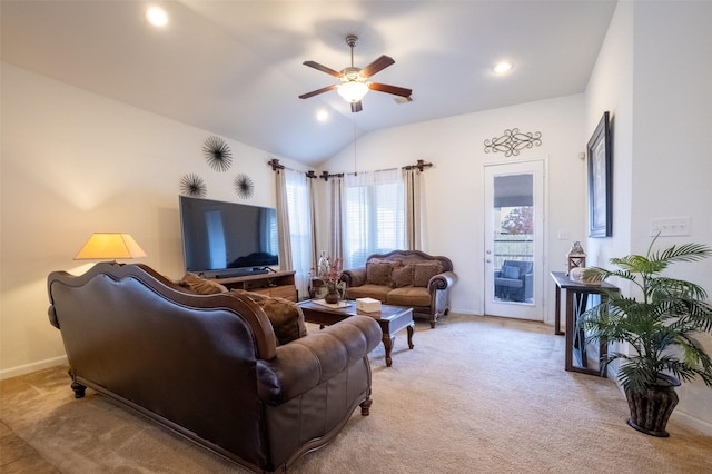 living room with vaulted ceiling, light colored carpet, and ceiling fan