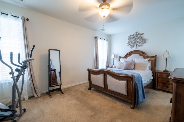 bedroom featuring ceiling fan and light carpet