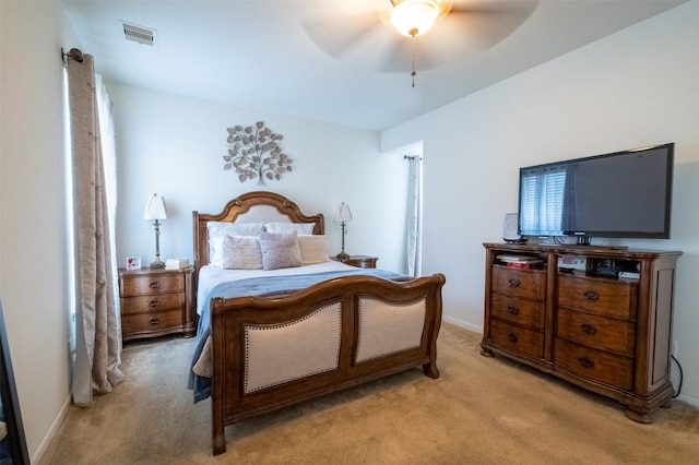 bedroom with light carpet and ceiling fan