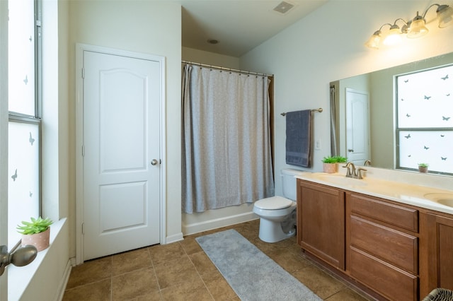 full bathroom with shower / tub combo, vanity, tile patterned flooring, and toilet