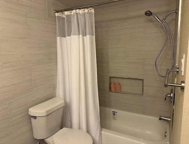 bathroom featuring shower / bath combination with curtain, toilet, and tile walls