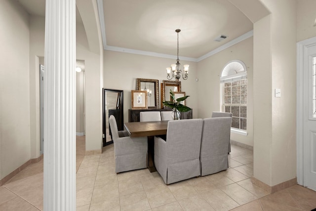 tiled dining room featuring crown molding and an inviting chandelier