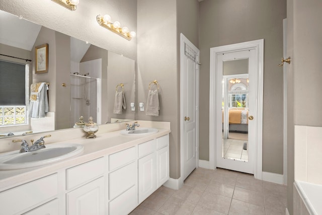 bathroom featuring vanity, tile patterned floors, plenty of natural light, and independent shower and bath