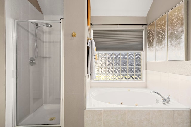 bathroom featuring lofted ceiling and independent shower and bath