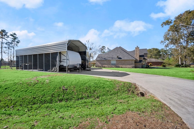 view of yard with a carport and a sunroom