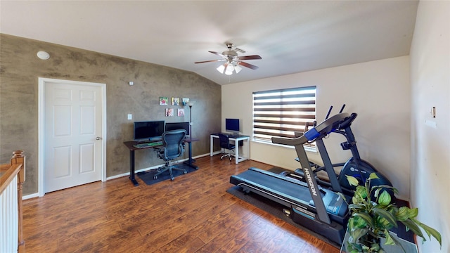 exercise room featuring ceiling fan, lofted ceiling, and dark wood-type flooring