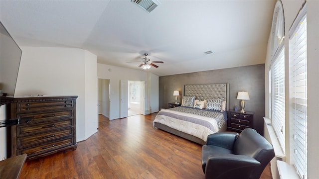 bedroom featuring connected bathroom, ceiling fan, dark hardwood / wood-style flooring, and lofted ceiling