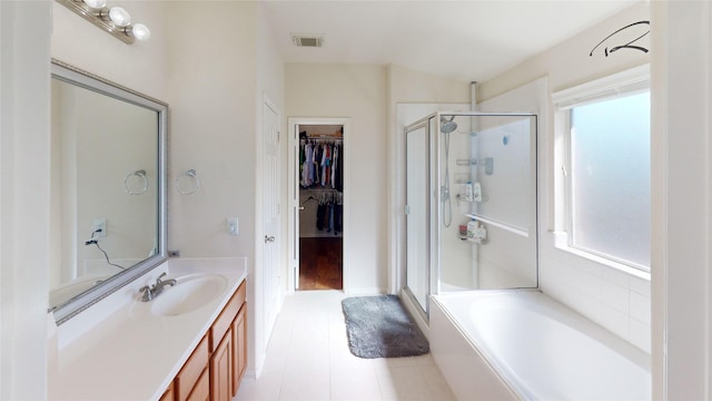 bathroom featuring tile patterned floors, a wealth of natural light, vanity, and independent shower and bath