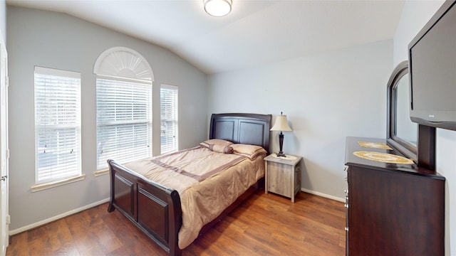 bedroom featuring dark hardwood / wood-style flooring and lofted ceiling