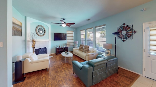 living room featuring hardwood / wood-style floors and ceiling fan