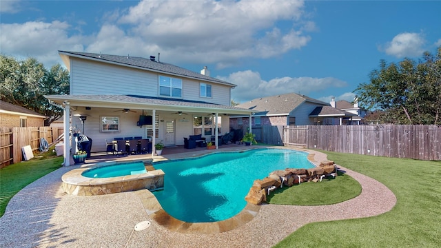 view of swimming pool featuring an in ground hot tub, a yard, ceiling fan, and a patio area