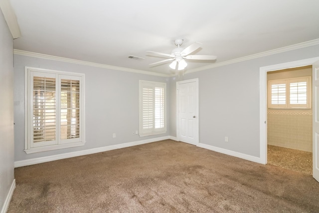 spare room featuring a healthy amount of sunlight, carpet floors, and ornamental molding