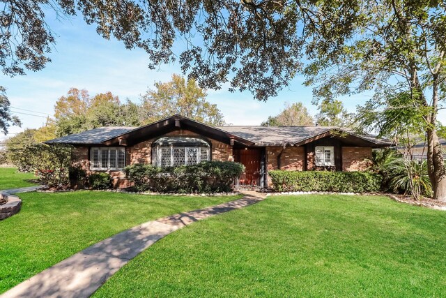 ranch-style home with a front lawn