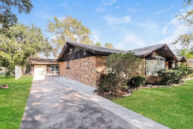 view of front of house with a garage and a front lawn