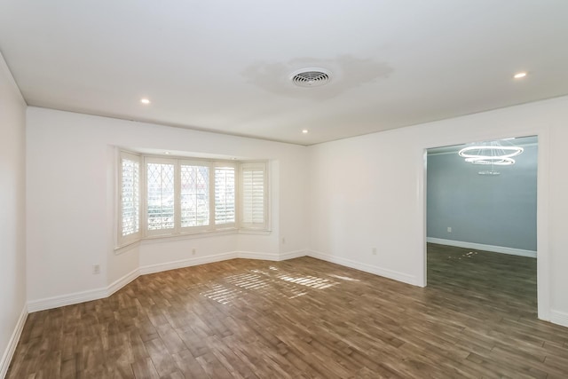 spare room with dark hardwood / wood-style floors