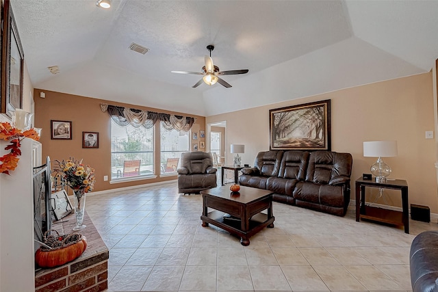 living room with light tile patterned floors, a textured ceiling, vaulted ceiling, and ceiling fan