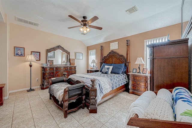 tiled bedroom featuring a textured ceiling, ceiling fan, and vaulted ceiling