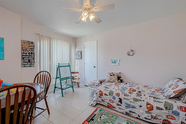 bedroom with ceiling fan and light tile patterned flooring