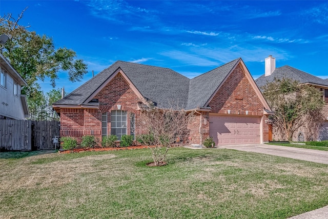 view of front of house with a front lawn and a garage