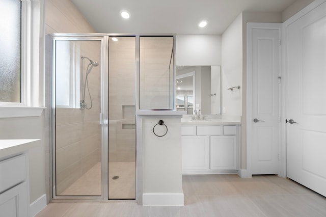 bathroom with tile patterned flooring, vanity, and an enclosed shower