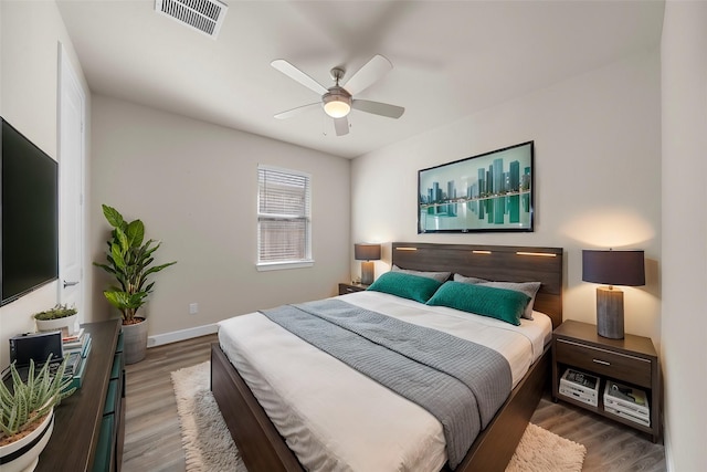 bedroom featuring ceiling fan and dark hardwood / wood-style flooring