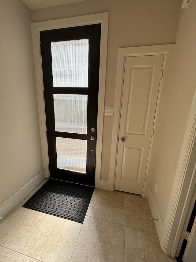 entryway with light tile patterned floors