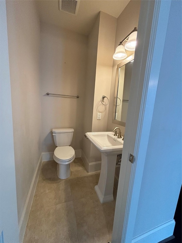 bathroom with tile patterned floors and toilet