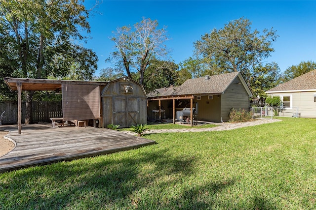 view of yard featuring a storage unit and a deck