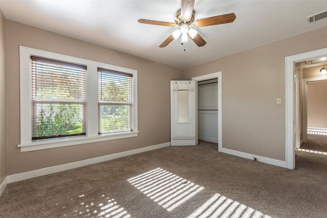 unfurnished bedroom featuring ceiling fan, carpet floors, and a closet