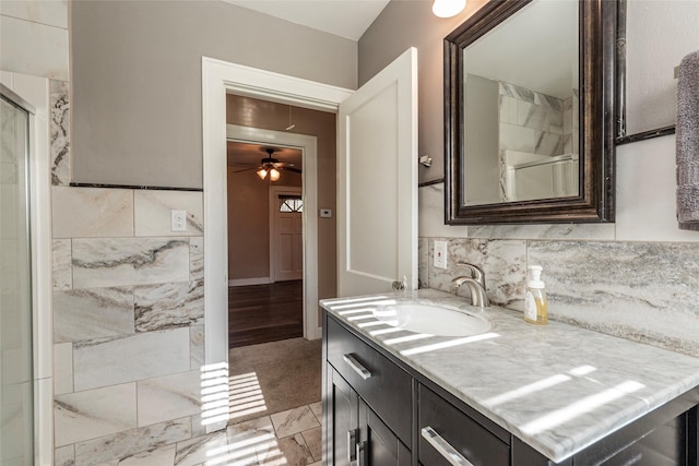 bathroom featuring vanity, ceiling fan, and a shower with shower door