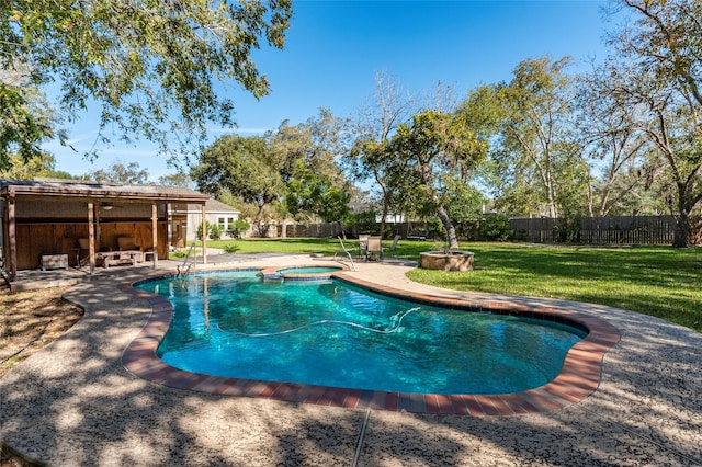 view of pool with an in ground hot tub, a patio area, and a lawn