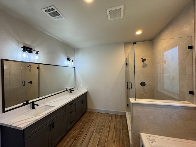 bathroom featuring vanity and an enclosed shower