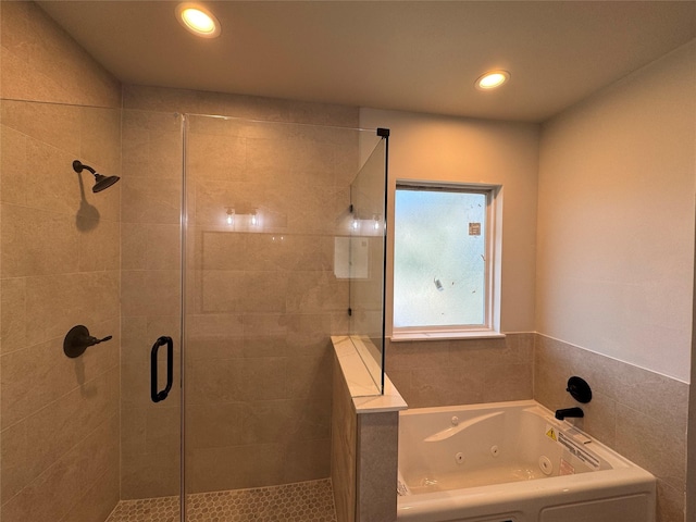 bathroom with a whirlpool tub, a stall shower, and recessed lighting