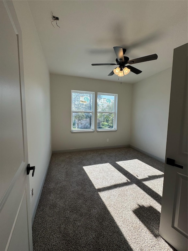 spare room featuring a ceiling fan, carpet flooring, and baseboards