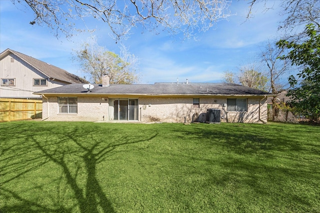 back of house featuring a lawn and central AC