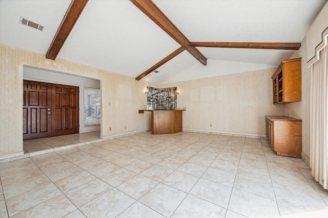 unfurnished living room with lofted ceiling with beams