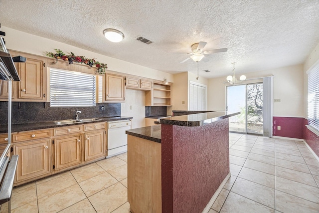 kitchen with dishwasher, light tile patterned flooring, ceiling fan with notable chandelier, sink, and a kitchen island