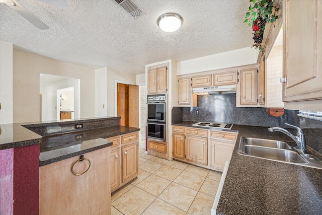 kitchen with sink, black double oven, decorative backsplash, light tile patterned floors, and light brown cabinetry