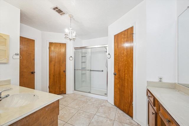 bathroom featuring tile patterned flooring, a notable chandelier, an enclosed shower, and a textured ceiling