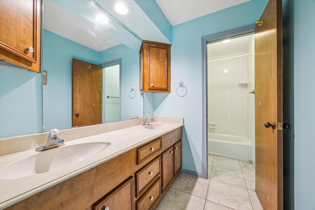 bathroom with tile patterned flooring, vanity, and tiled shower / bath combo