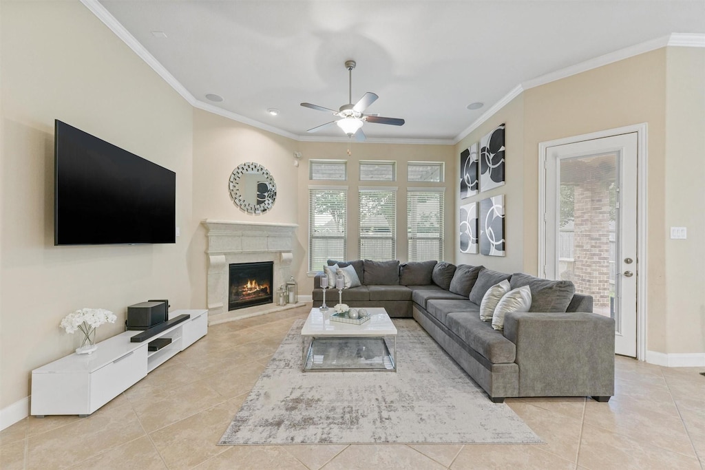 living room with light tile patterned floors, crown molding, and ceiling fan