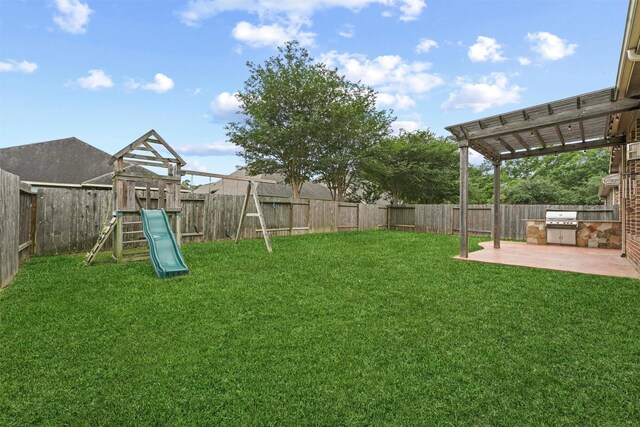 view of yard with a pergola, a patio, and a playground