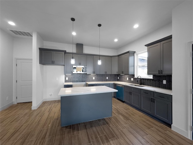 kitchen with a center island, dark hardwood / wood-style flooring, stainless steel appliances, and sink