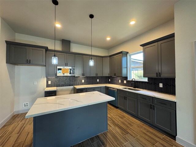 kitchen featuring a center island, sink, hanging light fixtures, dark hardwood / wood-style floors, and stainless steel appliances