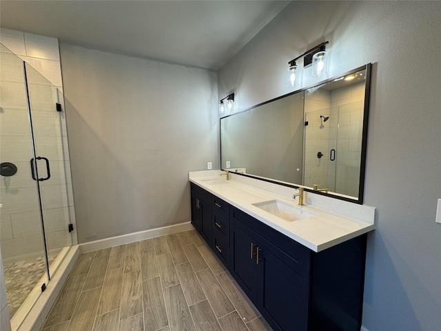 bathroom featuring vanity, an enclosed shower, and hardwood / wood-style flooring