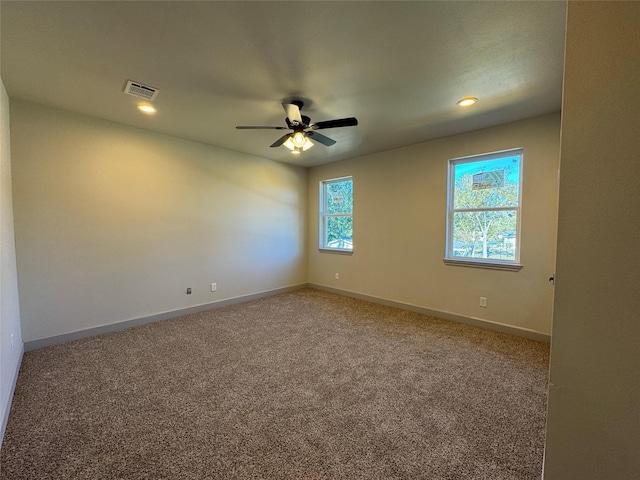 spare room with ceiling fan and carpet floors