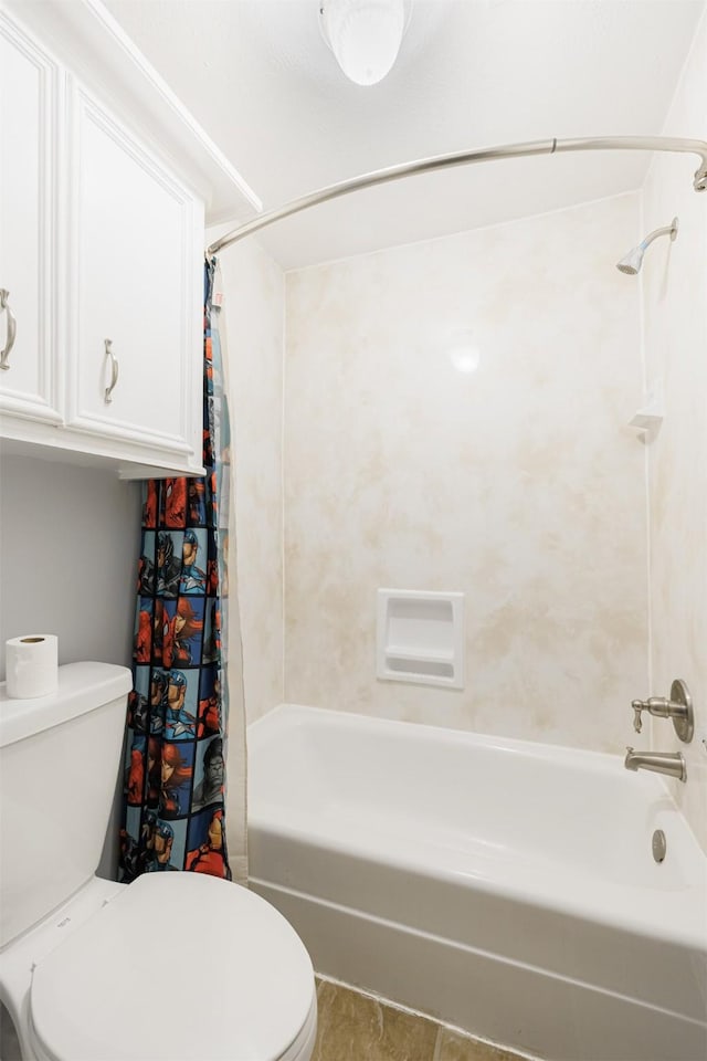 bathroom with tile patterned floors, shower / bath combo, and toilet