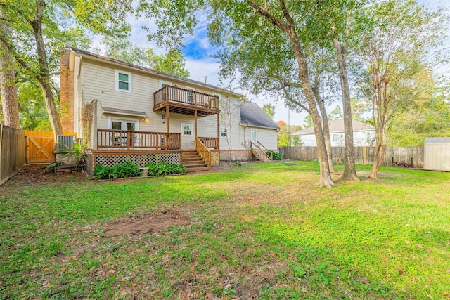 back of house with a yard, a balcony, and a deck