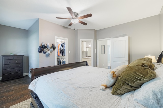 bedroom with ceiling fan, a spacious closet, connected bathroom, dark hardwood / wood-style flooring, and a closet