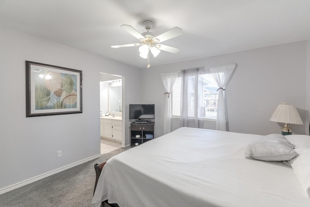 carpeted bedroom featuring ceiling fan and ensuite bath